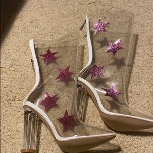 Clear, high heel boots with purple glitter stars.